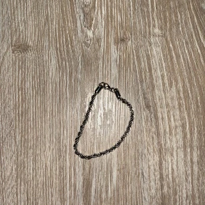 Cordell armband - Snyggt silverfärgat armband med en elegant tvinnad design. Perfekt för att ge en stilren touch till din outfit. Armbandet har en enkel låsning som gör det lätt att ta på och av.