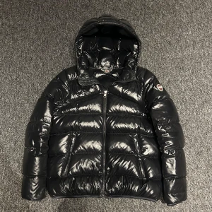 Colmar jacka - Säljer en snygg svart pufferjacka från Colmar i mycket bra skick. Jackan har en glansig finish och är perfekt för kalla dagar. Den har en dragkedja framtill och två praktiska fickor med dragkedjor. Huvan är vadderad för extra värme. Perfekt för vintern! 🖤 stl 16y. Passar runt 155-170cm. Riktigt bra skick!! Nypris är runt 5000kr. Hör av er för andra frågor och funderingar 