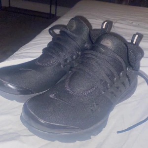 Nike air presto - Snygga svarta nike air presto skor för bra pris köpte begagnat för inte så länge sen bara en liten skada som man kan se på bilderna men inget stort och syns knappt