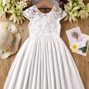 Vita klänningar st. 110 och 140  med spetsdetaljer - Charmig vit klänning med spetsdetaljer på överdelen och korta ärmar. Kjolen är flödande och ger en elegant look. Perfekt för sommarens festligheter.