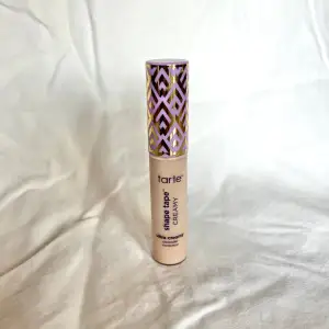 Säljer en Tarte Shape Tape Ultra Creamy Concealer i nyansen 16N Fair-Light Neutral. Den har en krämig konsistens som ger bra täckning och är perfekt för att dölja mörka ringar och ojämnheter. Använd fåtal gånger, totalvikt: 25g.