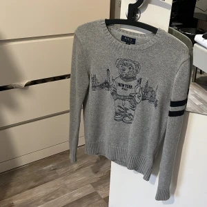 Polo Ralph Lauren The Bear (stickad) - Hej, säljer denna polo ralph lauren tröja då jag växt ur den, köpt för ca 2 år sedan. Värt att de är att de är barn storlek men den största bland dom, passar ca 150-165cm. Den är stickad och en utav dom mer exklusiva tröjorna som ralph lauren säljer!