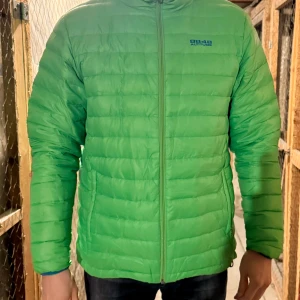 Grön dunjacka från 8848 Altitude - Säljer en grön dunjacka från 8848 Altitude i storlek L. Jackan har quiltad design, dragkedja framtill och lång ärm. Perfekt för kyliga dagar och enkel att bära tack vare lättviktsmaterial. Har varit med ett tag men fungerar utan problem eller defekter. Lättviktsdunjacka