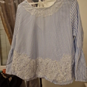 Blue striped blouse  - Elegant striped light blue blouse with detaile white lace.