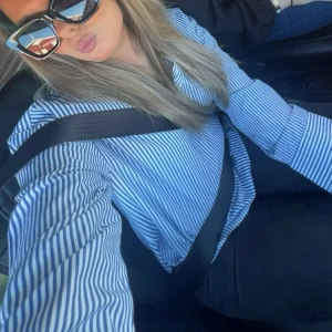 Blåvit randig skjorta -  en  blåvit randig skjorta, från H&M. Den har inga knappar. Använd några gånger men i fint skick