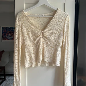 Vit spetsig croppad långärmad topp - Endast använd en gång. Storlek L men passar en S då den är liten och kort i vanliga fall. 