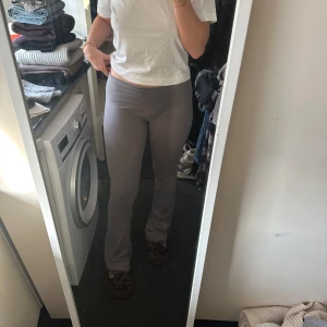 Grå tighta leggings - Säljer ett par grå leggings med tight passform och hög midja. Byxorna är enkla och stilrena utan synliga detaljer, perfekta för en avslappnad look.