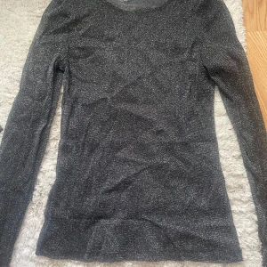Glittrig tröja  - Glittrig genomskinlig tröja från Kappahl. Jätte bra skick, endast använd en gång. Skriv om ni vill ha fler bilder! Storlek XS💗