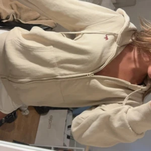 Beige hoodie med dragkedja - Säljer en beige hoodie med dragkedja och huva. Perfekt för chill dagar och enkel att matcha med det mesta. Den är i storlek M och är ifrån Funky Buddha! Skriv om ni undrar nått!❤️