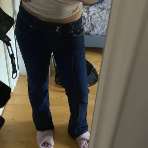 Mörkblå bootcut jeans med låg midja - Säljer ett par mörkblå jeans med bootcut-modell och låg midja. Jeansen har klassiska fickor med snygga detaljer där fram. Snygg passform och perfekt för alla tillfällen. De kommer inte till användning då jag köpte fel storlek☺️