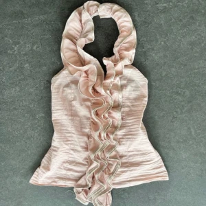 Ljusrosa halterneck topp med volang  - Supersöt ljusrosa topp från TFNC London med stora volanger längs halsringningen och framtill. 