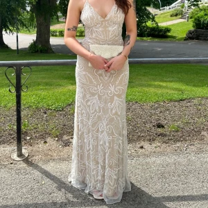 Unik balklänning - Otroligt fin balklänning som jag köpte på Vinted förra året. Den är defekt/trasig/smutsig nere på ”släpet” då det har skrapats i backen. Axelbanden är missfärgade pga bus, det var så när jag köpte den, men det är inget som syns när banden ligger emot kroppen. Vet inte original pris men jag köpte den för ungefär 1700kr. Tror det är Storlek S men passar också M. Väldigt lång. Mönstret är paljetter/pärlor som är fastsydda i klänningen🌸