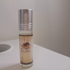 Choco Musk parfymolja Crown Perfumes - Choco Musk parfymolja från Crown Perfumes i en liten glasflaska med silverfärgat metallock. Doften är söt och krämig med tydliga toner av choklad och vanilj. Flaskan rymmer 0,2 fl oz och har en beige etikett med guldiga detaljer och chokladmotiv.