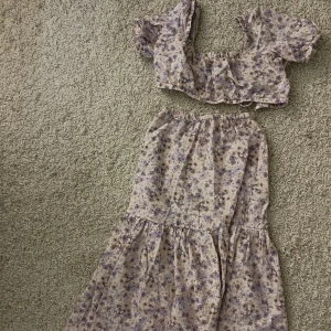 Blommigt linne det - Underdelen använd en gång i storlek xs. Tröjan är xs med knyten i ryggen. Priset är för hela setet