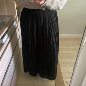 Svart plisserad långkjol - Säljer en svart plisserad långkjol från vila.Sitter lite kort på mig som är 165 men de är en smak sak.Pris går att diskutera💕