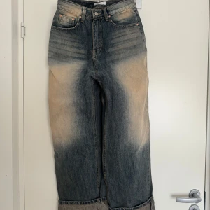 Jeansbyxor från Lewkin - Snygga jeansbyxor från Lewkin med en unik blekningseffekt. Byxorna har en loose passform som ger en avslappnad stil. Perfekta för en trendig look.