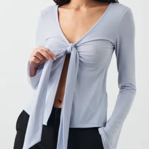 Ljusblå knytblus - Säljer en stilren ljusblå blus med knyt framtill och v-ringning. Blusen har långa ärmar och en elegant design som passar perfekt för olika tillfällen. Om ni vill ha fler bilden kom privat💕