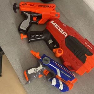 Nerf (leksakspistol) - Bilderna visar tre olika Nerf-leksakspistoler: Accustrike Quadrant, Mega Tri-Break och Firestrike. Dessa färgglada blasters är perfekta för actionfyllda Nerf-strider med vänner. Firestrike har även en inbyggd laserpekare för extra precision. Perfekt för dig som gillar lek och tävling! Mega nerf koster cirka 499kr nypris och laser cirka 289kr och orange nerf cirka 400kr, mitt pris totalt för alla tre är 700kr men kommer sänka 