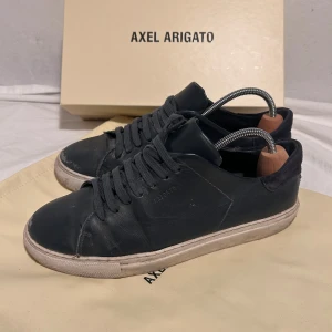Axel Arigato Skor Herr - Tjena! Säljer nu mina gamla arigatos då jag inte använder dem längre. Skorna är i ett använt skick men dem funkar fortfarande prima! Skorna är i storlek 41 och box samt dust bag medföljer. Fler frågor är det bara att höra av dig!