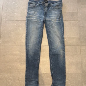 Blå slim fit jeans med slitningar - Snygga blå jeans med slim fit passform från blk dlm, nypris 1700.