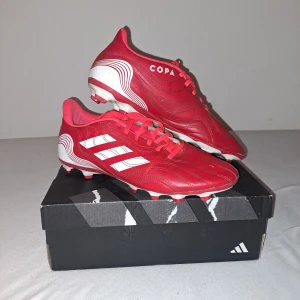 Röda Adidas Copa Sense 4 - Snygga röda Adidas Copa fotbollsskor. De har varit lite använda men de funkar fint.