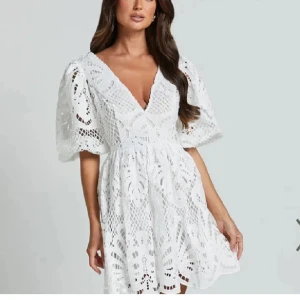 Studentklänning - Superfin slutsåld vit klänning med v-ringad hals och puffärmar. Klänningen har ett vackert spetsmönster och är kort i modellen. Perfekt för studenten!💕💕storlek L men sitter som M