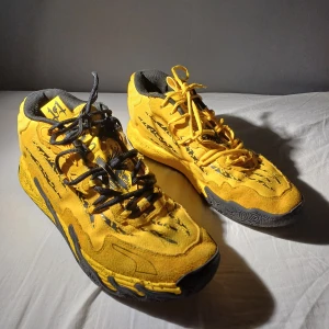PumaXLaMeloXPorsche-MB.03 - Ett par gula mb.03 porscheXLaMelo skor. Använda i ett par månader. Det finns flera olika skosnören som skickas med i beställningen. QR koden leder till puma webbsidan. Skriv för fler bilder!!