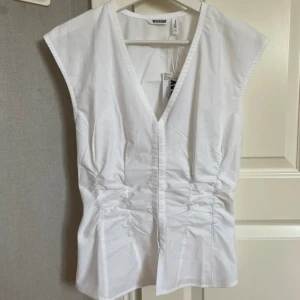 Vit topp weekday - Snygg topp från weekday, insydd vid midjan