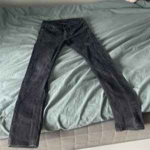 Svarta nudie jeans - Säljer ett par riktigt snygga nudie jeans, i strl 28/32. Jeansen är tighta runt midjan och lång i längden. Om du är runt 170 cm lång är dom här byxorna för dig!
