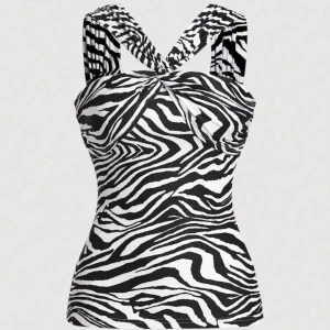 Zebramönstrad linnetopp med twistade axelband - Snygg linnetopp med svartvitt zebramönster och twistade axelband som korsas i ryggen. Toppen har figurnära passform och är tillverkad i mjuk, stretchig polyester. Perfekt för dig som vill sticka ut med ett djurmönster och coola detaljer.