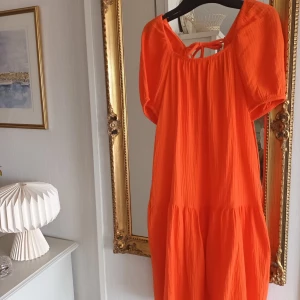 Apelsinfärgad sommarklänning 100% bomull. - Fin och sval klänning i 100% bomull stl XS men upplever att den XS-S. Nyskick, sparsamt använd. 