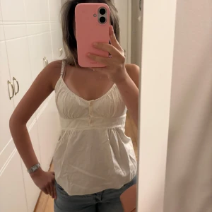 Vit linnetopp från BRANDY MELVILLE storlek S/M - Säljer en söt topp från BRANDY MELVILLE i storlek S/M. Toppen har en lätt rynkad byst och markerad midja som ger en avslappnad och luftig känsla. Toppen är i mycket bra skick!Perfekt till jeans eller shorts för en chill look.