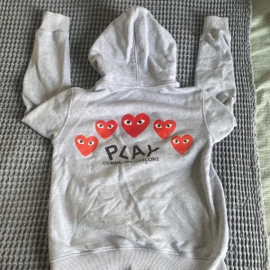 Grå hoodie från Comme des Garçons - Stilren hoodie som blivit för liten. Snyggt tryck och bra passform. Defekt vid snören men inget man tänker på jättemycket (bild 3)