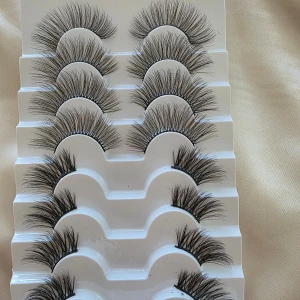 Set med lösögonfransar - Säljer ett set med flera par lösögonfransar. Fransarna är långa och fylliga, perfekta för att ge en dramatisk look. De kommer i en praktisk förpackning som håller dem organiserade.