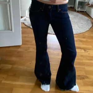 Bootcut Wrangler jeans - Snygga mörkblå bootcut jeans med låg midja. Inga defekter förutom att dem är avklippta där nere vid fötterna. Midjemåttet är 38cm rakt över. Innerbenslängden är ca 75cm. Skriv om du har frågor🥰