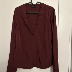 Vinröd blus från Gina Tricot - Vinröd blus från Gina Tricot i strl. 34. 