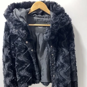 Vinter jacka - En svart fluffig vinter jacka, materialet är väldigt mjuk och förstörs inte när den tvättad 