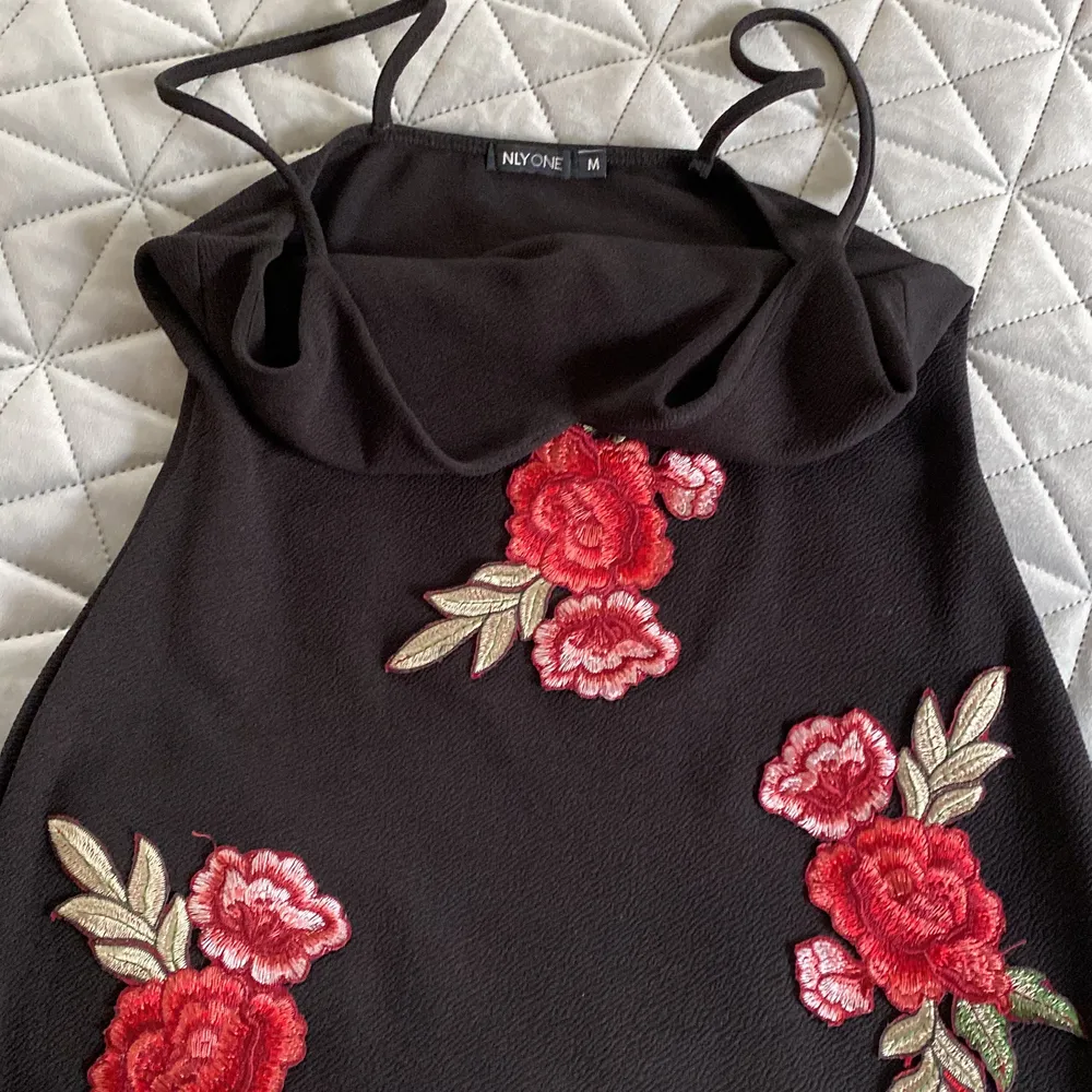 klänning från nelly, använd endaste en gång. svart med röda rosor. köpare står för frakten💕. Klänningar.