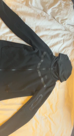 Nike Tech Fleece - Säljer den för den ej kommer till användning, använd circa 3-5 gånger😊 Köpt från plick tidigare så säljer därför för billigare pris❤️ Den är i fint skick med några små fläckar men tvättas innan postning😊 147-158 cm( Skriv till mig för info eller bilder❤️