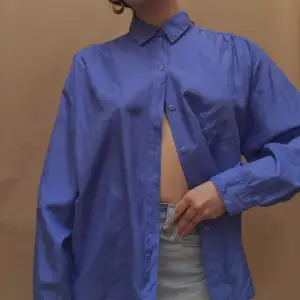 Vintage Structured Silk Blouse with Pocket Detail Slight Sheen that picks up light Gorgeous Blue color Silk Composition Worn Oversized Best Fits Size S