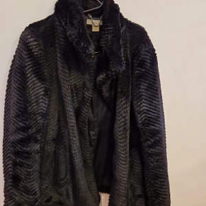 Fake fur - En fake fur kappa, svart från H&M , fickor på sidan , sitter väldigt snyggt på kroppen! 