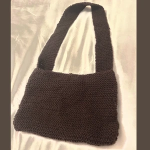 Stickad väska - Säljer denna egentillverkade väska för 150kr + frakt. Det är en brun, stickad axelremsväska som har en längre axelrem, därav rekommenderad för en längre person. 
