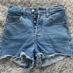 Levi's shorts - Säljer ett par jeansshorts från levis. Använd ett fåtal ggr. Har en sminkfläck på ena sidan som ej gått bort i tvätten. Skulle säga att storleken är som en xxs. 