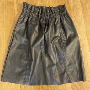 Kjol i fejkskinn - Snygg kjol i fejkskinn  Aldrig använd  Etikett kvar