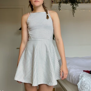 Randig klänning H&M - En vit-och svartrandig klänning från H&M divided. Banden går att förlänga. Tvättas i 40°C. ✨