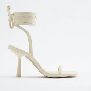 Vita klackar - Vita klackar som knyts med remmar upp på benet från Zara. Superfina och endast använda en gång. Klackhöjd 9cm enligt hemsidan. Slutsålda. Äkta skinn💖