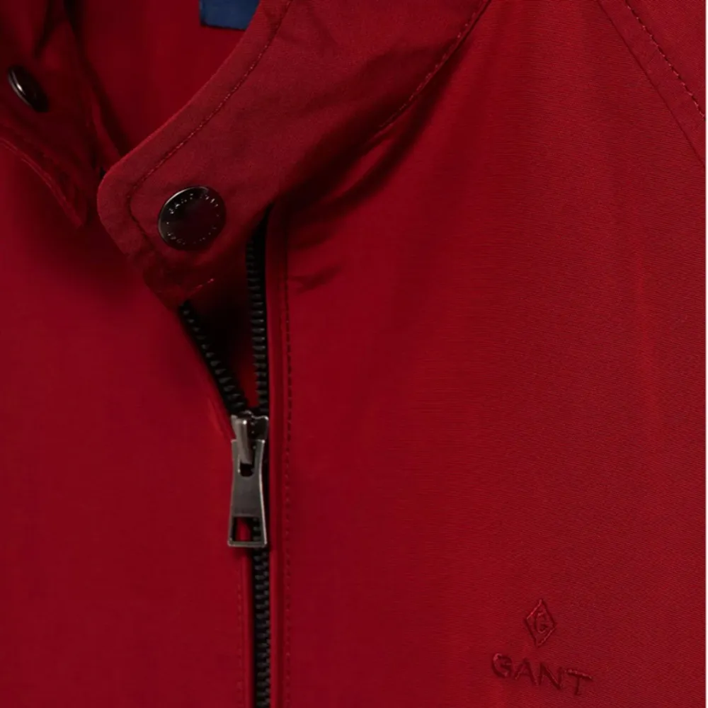 Ny Röd vårjacka från Gant. Muddar i ärmslut, broderad logotyp på bröstet, kort ståkrage samt fickor med lock, Aldrig använt. Köptes för: 2499. Jackor.