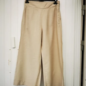Vida byxor från Lindex  - Vida, något utsvängda kortare byxor i 90% viscose och 10% polyester. Oanvända med lappen kvar. 