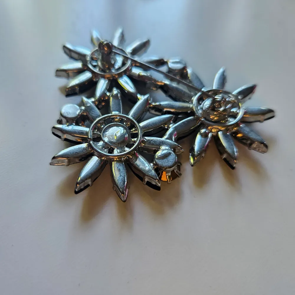 Tjena, säljer denna blommiga brochyren som har en pin där bak, vilket gör det möjligt att sätta på kläder, väslor, mässor etc.. . Accessoarer.