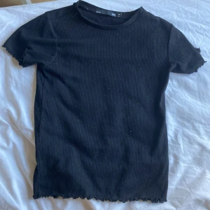 Svart t-shirt🖤💗 - En svart t-shirt med volanger vid varje hål 🕳️ 